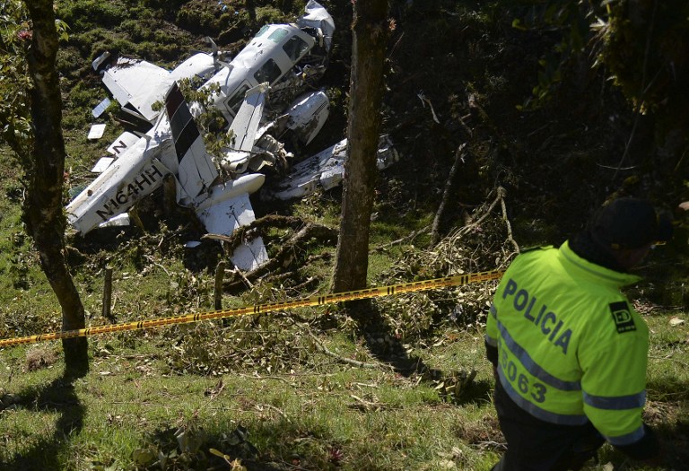 Colombian Police custody  the wreckage of a Piper PA-60 Aerostar twin-engine aircraft that crashed on the eve,  on September 12, 2015 near San Pedro de los Milagros , east from Medellin, Antioquia department, Colombia  on September 12, 2015. killing two crew members and injuring another. Two people died when a plane carrying crew members from a film starring Tom Cruise crashed in Colombia, aviation authorities and Universal Pictures said. AFP PHOTO / Raul ARBOLEDA