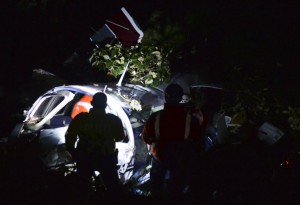 Rescuers inspect the wreckage of a Piper PA-60 Aerostar twin-engine aircraft that crashed on September 11, 2015 near  San Pedro de los Milagros , east from Medellin, Antioquia department, Colombia killing two crew members and injuring another. Two people died when a plane carrying crew members from a film starring Tom Cruise crashed in Colombia, aviation authorities and Universal Pictures said. AFP PHOTO / Raul ARBOLEDA