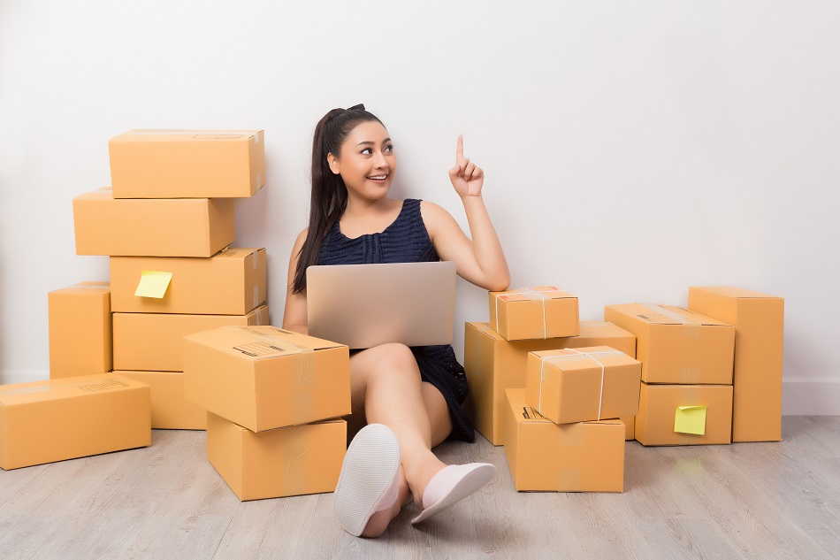business owner working at home office packaging on background. online shopping SME entrepreneur working Young Women happy after new order from customer.