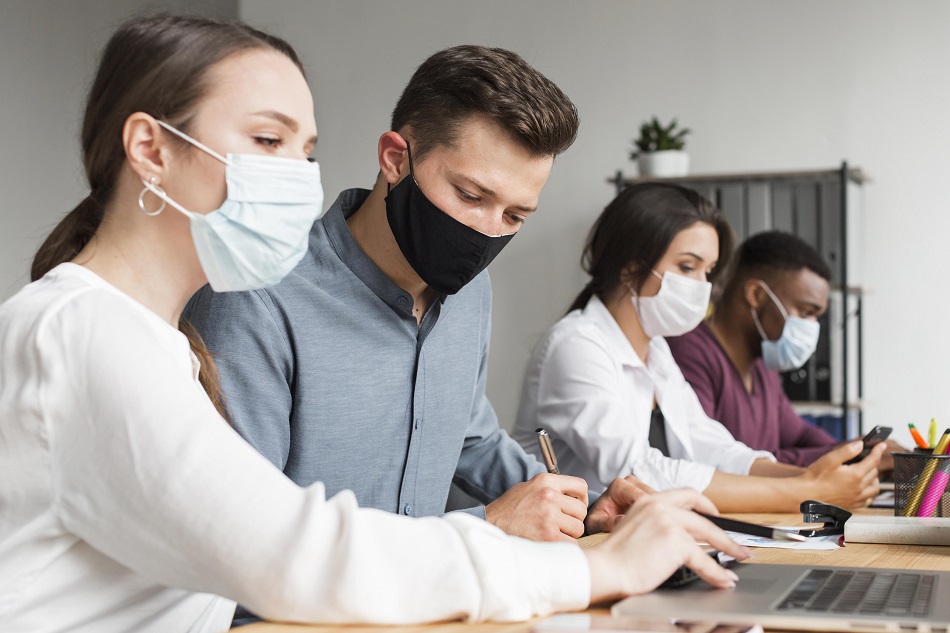 people-in-the-office-working-during-pandemic-with-masks-on